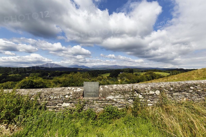 Memorial plaque in old stone wall overlooking rolling countryside, graveyard, St Garmons Church, Capel Garmon, Conwy, Wales, United Kingdom, Europe