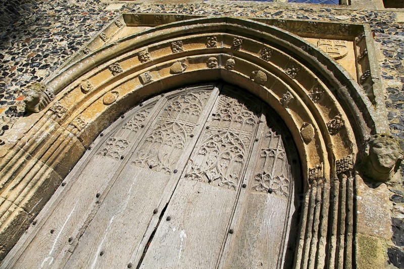 Carved stone wooden doorway arch, Church of All Saints, Brandeston, Suffolk, England, UK