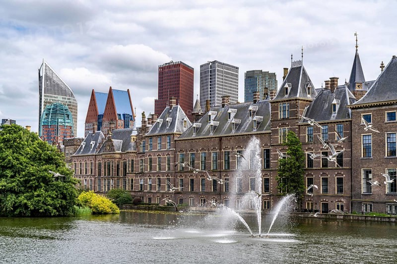 The historic Binnenhof, seat of the Dutch government, Hofvijver pond, skyline of the city centre at the central station, in the city centre of The Hague, Netherlands