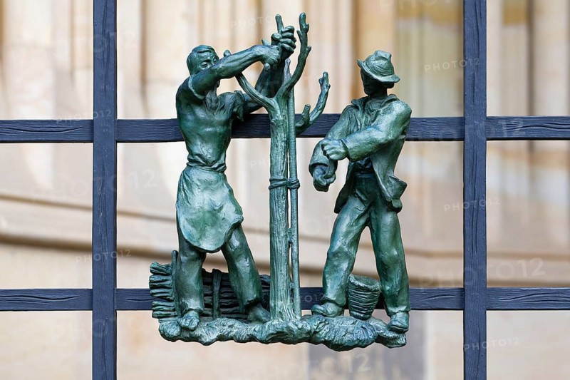 Prague castle, Gothic Metropolitan Cathedral of Saints Vitus, Wenceslas and Adalbert, Decorative figure of daily life scene on a fence, Prague, Czech Republic, Europe