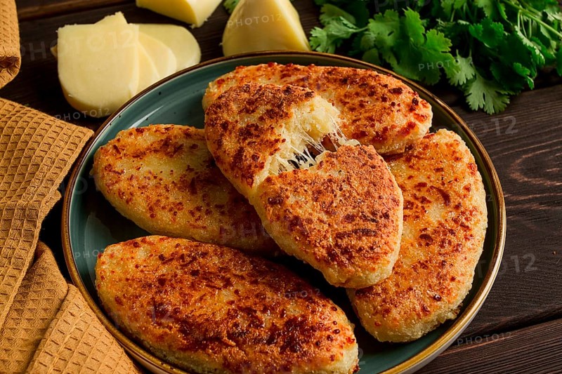 Chvishtari, corn flour tortillas with cheese, pastries, Georgian cuisine, Mchadi, homemade, top view, on a wooden table, no people