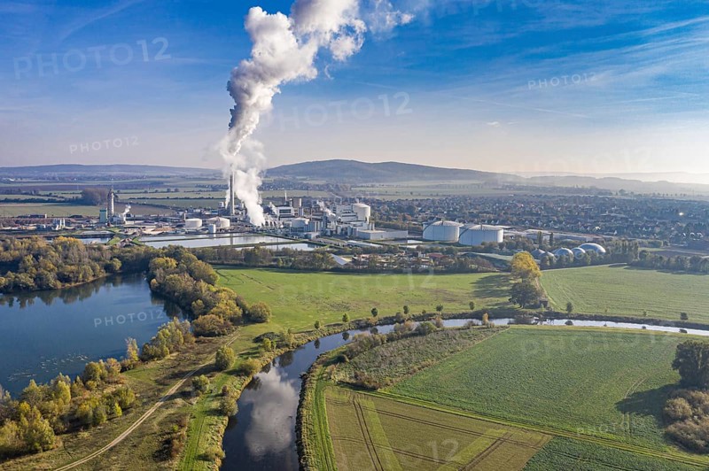 Drone shot of river Leine with Nordzucker sugar factory in Nordstemmen, smoking chimneys on a cold and sunny day, Germany, Europe