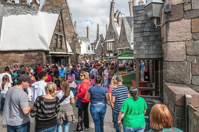 Theme park guests walk through Hogsmeade in The Wizarding World of Harry Potter at Universal Studios, Orlando, Florida, USA, North America