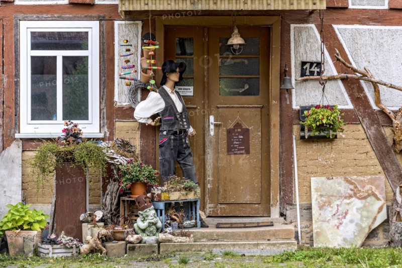 Old half-timbered house, entrance curiously decorated with mannequin in costume, carpenters' guild, traditional clothing, Nidda, Vogelsberg, Wetterau, Hesse, Germany, Europe