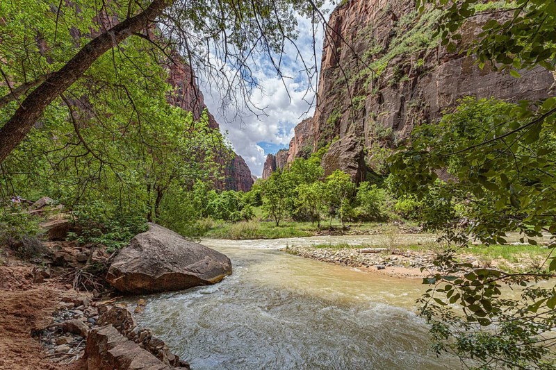Virgin River runs between sandstone rock formations along the Riverside Walk in the Temple of Sinawava area of Zion National Park, Utah