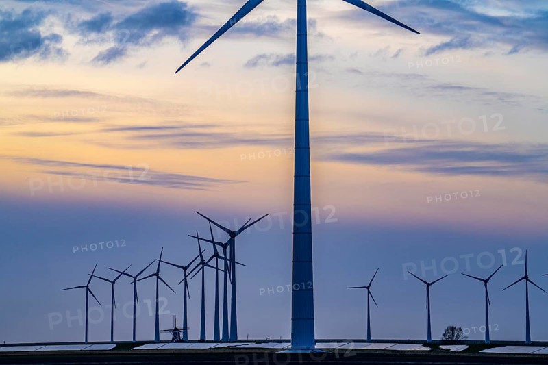 Windmill Poldermolen De Goliath stands between the high-tech wind turbines in Eemshaven, historic windmill from around 1882, rebuilt and reconstructed several times, Westereems wind farm, solar farm on sea dike, Slaperdijk, a good 5 kilometres long, Netherlands