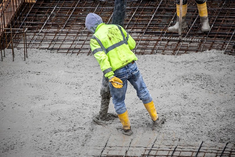 Construction site, concreting, the foundation of a building is concreted, the concrete is pumped onto the reinforced concrete mats