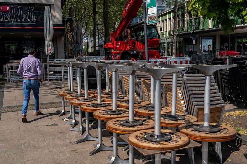 Stacked chairs and tables from various catering establishments, on Kennedyplatz, closed cafes, pubs, restaurants, effects of the corona crisis in Essen, Germany, Europe