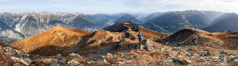 Panorama, mountaineer at the summit Kreuzjoch, view of summit Tschirgant and the Oberinntal and into the Pitztal, in autumn, Venet crossing, Ötztal Alps, Tyrol, Austria, Europe