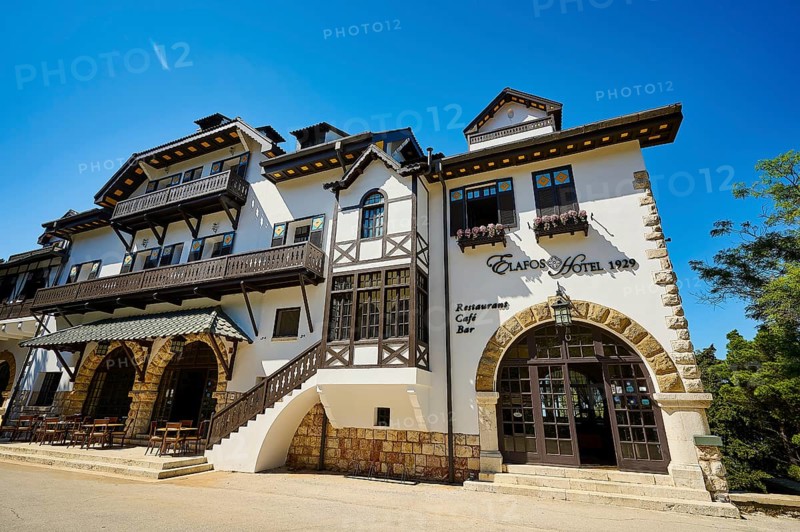 Historic white hotel with half-timbered walls, balconies and parasols on a sunny day, Elafos Hotel, Profitis Ilias, Rhodes, Dodecanese, Greek Islands, Greece, Europe