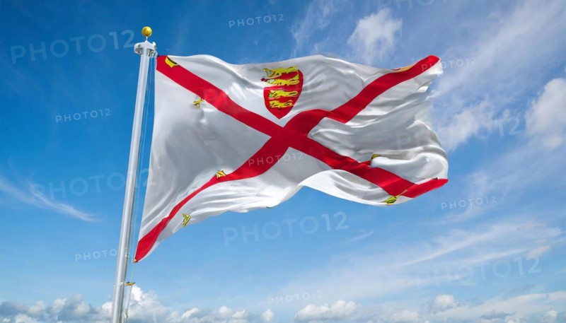 The flag of the Isle of Jersey, Great Britain flutters in the wind