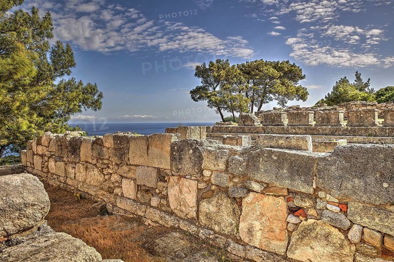 HDR, Ancient walls overlooking the sea, surrounded by lush vegetation and trees under a partly cloudy sky, Kamiros, Archaeological site, Ancient city, Foundation of Doric Greeks, Rhodes, Dodecanese, Greek Islands, Greece, Europe
