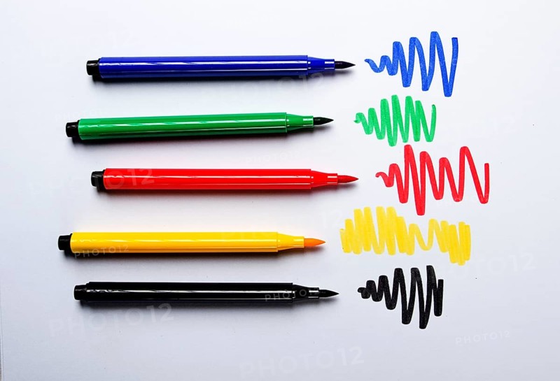 Watercolor pens brush, assortment, on a drawing album, artist's desk, top view, close-up, selective focus