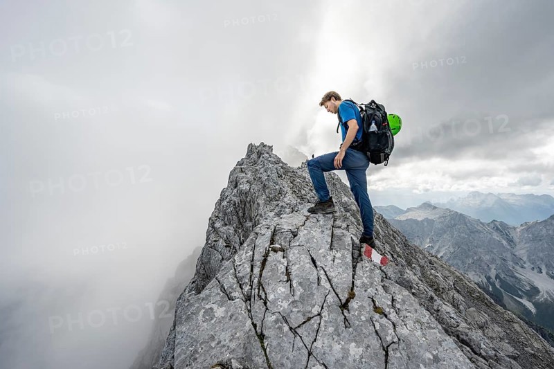 Mountaineer on a narrow rocky ridge, Watzmann crossing to Watzmann Mittelspitze, view of mountain panorama, Berchtesgaden National Park, Berchtesgaden Alps, Bavaria, Germany, Europe