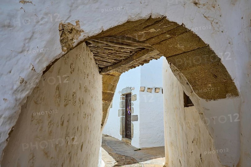 Narrow arched passageway with white walls and wooden beams in a quiet alley, Chora, Old Town, Patmos, Dodecanese, Greek Islands, Greece, Europe