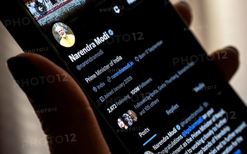 Guwahati, India. 15 July 2024. In this photo illustration, a person browsing X account formerly Twitter of Indian Prime Minister Narendra Modi on a smart phone on July 15, 2024 in Guwahati, India. Prime Minister Narendra Modi has reached 100 million followers on the social media platform X, making him the second most-followed politician globally after former US President Barack Obama