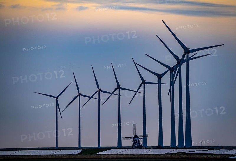 Windmill Poldermolen De Goliath stands between the high-tech wind turbines in Eemshaven, historic windmill from around 1882, rebuilt and reconstructed several times, Westereems wind farm, solar farm on sea dike, Slaperdijk, a good 5 kilometres long, Netherlands