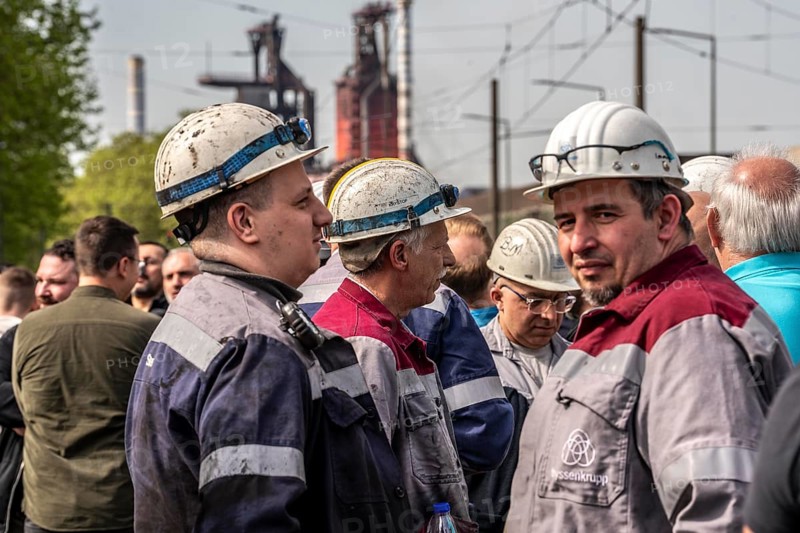 Steelworkers at a demonstration in front of the headquarters of ThyssenKrupp Steel Europe in Duisburg, against massive job cuts, after the participation of a foreign investor in the group, in the background the blast furnaces 8 and 9, Duisburg North Rhine-Westphalia, Germany, Europe