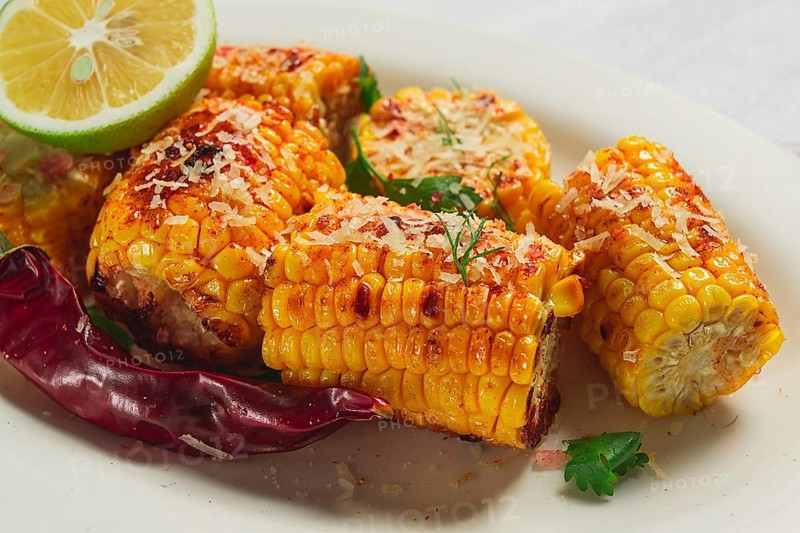 Grilled corn with spices, top view, no people, homemade