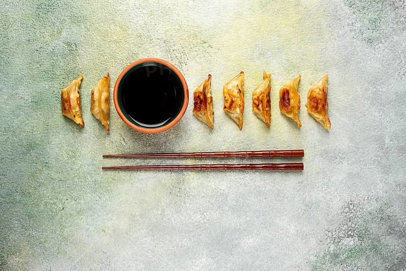 Japanese fried dumplings, gyoza, sesame seeds, top view, no people