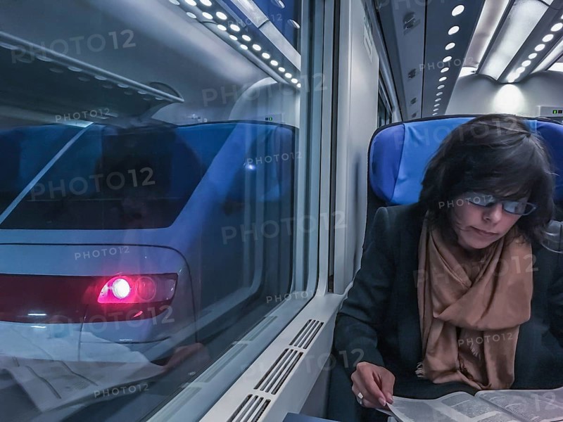 Woman Travel in a Train and Reading a Newspaper in Monte Carlo, Cote d azur, Monaco, Europe