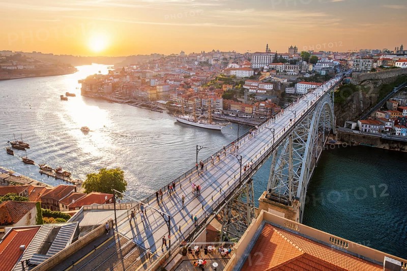 View of Porto city and Douro river and Dom Luis bridge I from famous tourist viewpoint Miradouro da Serra do Pilar on sunset. Porto, Vila Nova de Gaia, Portugal, Europe