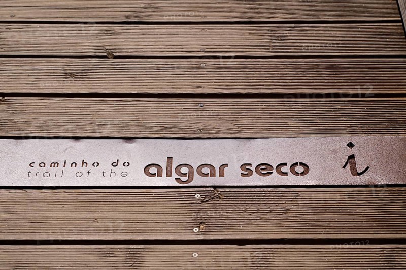 Lettering, logo on wooden boardwalk, wooden walkway, boardwalk, coastal hiking trail, Caminho de Algar Seco, coloured rocks and caves, shell limestone, Carvoeiro, Algarve, Portugal, Europe