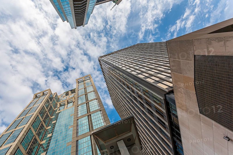 Clouds can be seen in the sky looking up between the skyscrapers in downtown Nashville, Tennessee, USA, North America
