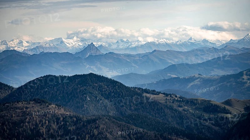 View of the Alpine foothills and main Alpine ridge with snow-covered peaks of the Zillertal Alps, from the Austrian Schinder, Bavarian Alps, Mangfall mountains, Bavaria, Germany, Europe