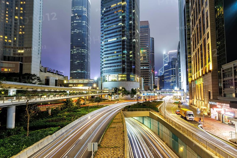 Traffic with streets and skyscrapers in the city of Hong Kong at night in Hong Kong, China, Asia