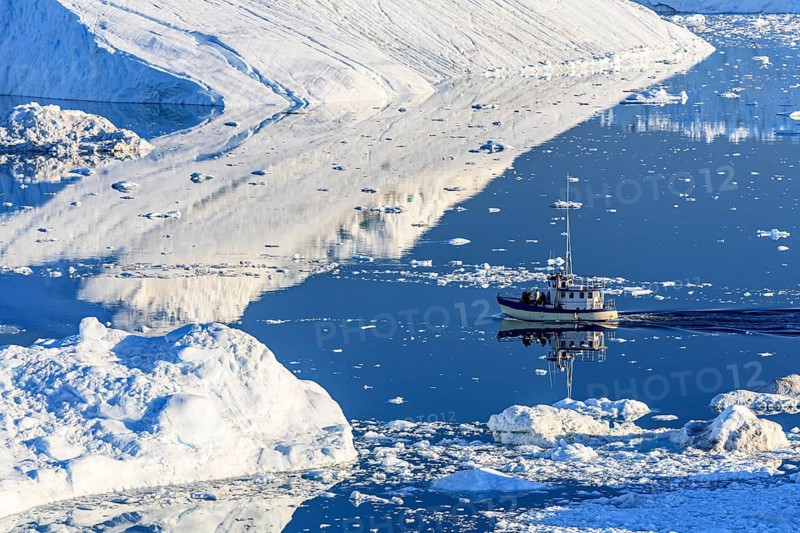 Boat sailing through icebergs and ice floes, reflected in the water, sunny, summer, Jakobshavn Glacier and Icefjord, Ilulissat Kangerlua, Disko Bay, West Greenland, Greenland, North America