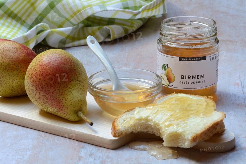 Pear jelly in a bowl and glass, pear jelly on a slice of bread