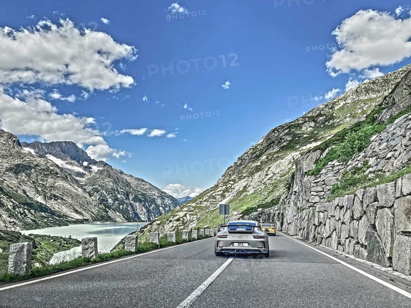 Photo with reduced saturation Porsche 911 GT3 on pass road of Grimselpass, Canton Uri, Switzerland, Europe
