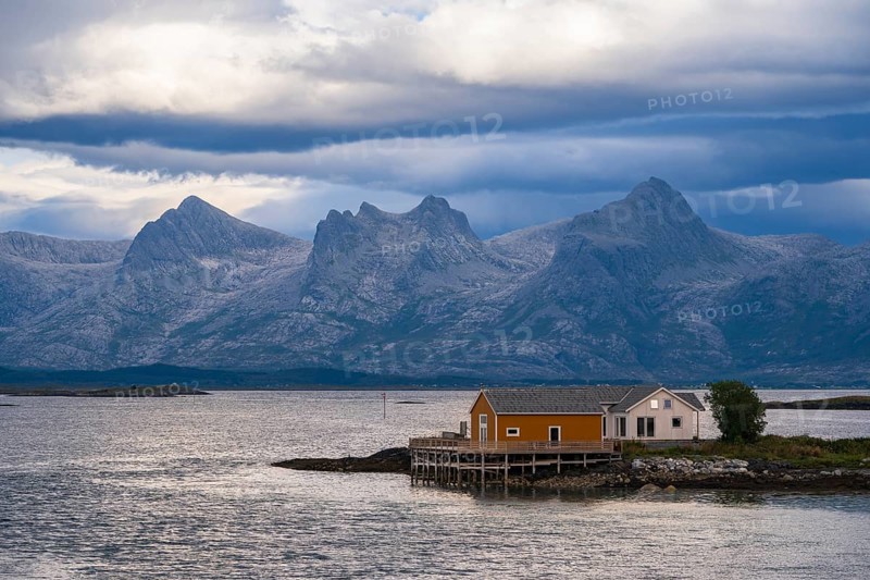 Boathouse on the shore, the Seven Sisters mountain range behind, Heroy island, Helgeland coast, Nordland, Norway, Europe