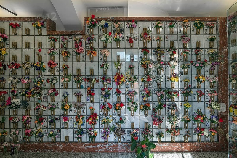 Urn graves with floral decorations in a hall at the Monumental Cemetery, in Genoa, Genoa, Italy, Europe