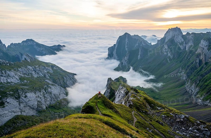 Two hikers enjoying the view over the SÃ¤ntis mountains into the valley of Meglisalp at sunrise, high fog in the valley, SÃ¤ntis, Appenzell Ausserrhoden, Appenzell Alps, Switzerland, Europe