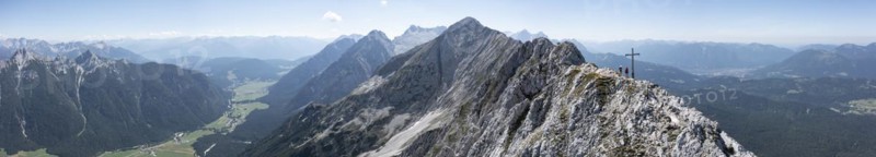 Aerial view, Alpine panorama, hikers at the summit cross, Westliche Wettersteinspitze, Wetterstein Mountains, Bavaria, Germany, Europe