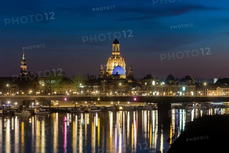 The Church of Our Lady with the glass dome over the octagon of the Academy of Arts, which is illuminated in blue in protest against the war in Ukraine