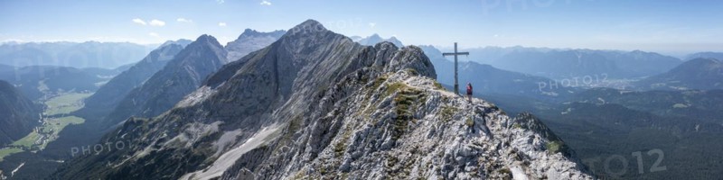 Alpine panorama, hikers at the summit cross, Westliche Wettersteinspitze, Bavaria, Germany, Europe