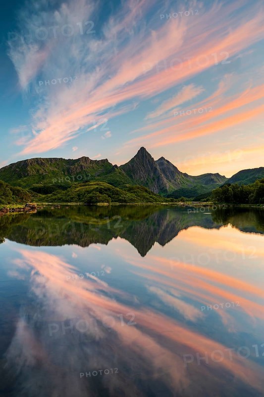 Mountains and clouds reflected in the sea, evening mood, near Sto, Langoya Island, Vesteralen, Northern Norway, Norway, Europe
