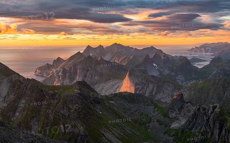 View over mountain top and sea, dramatic sunset, from the top of Hermannsdalstinden, Moskenesöy, Lofoten, Nordland, Norway, Europe