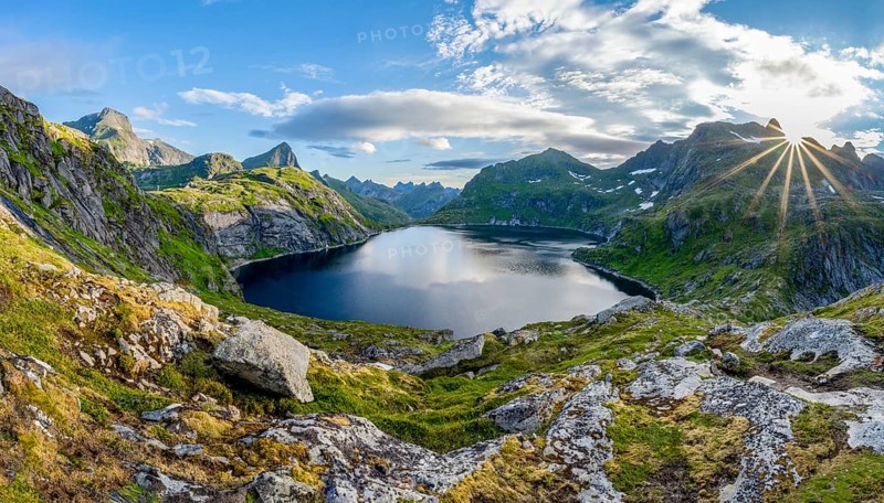 Mountain landscape with steep rocky peaks and lake Tennesvatnet, Sun Star, Moskenesoya, Lofoten, Nordland, Norway, Europe