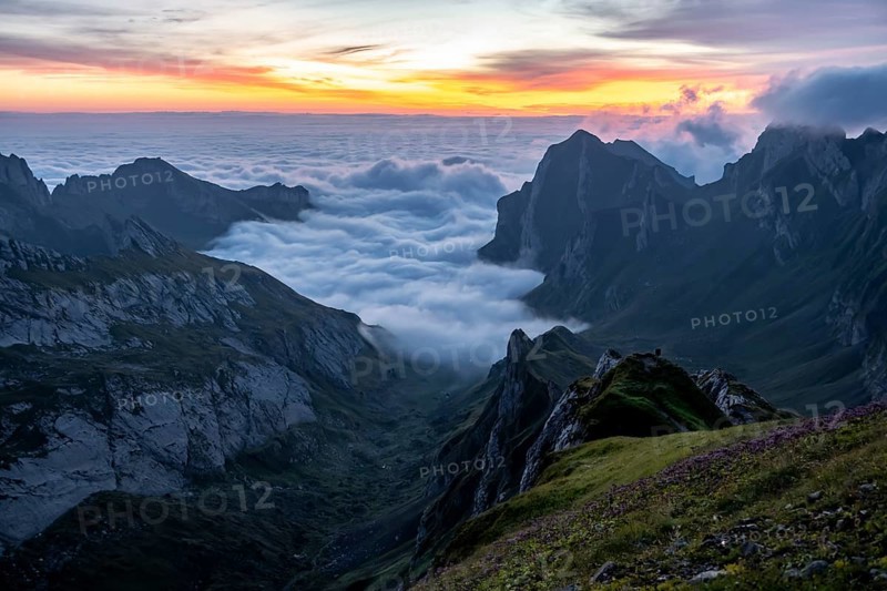 View over SÃ¤ntis mountains into the valley of Meglisalp at sunrise, high fog in the valley, SÃ¤ntis, Appenzell Ausserrhoden, Appenzell Alps, Switzerland, Europe