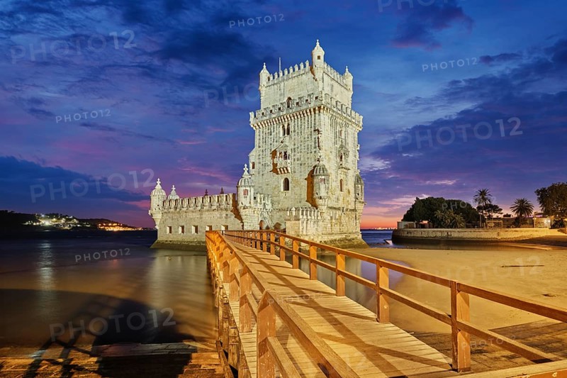 Belem Tower or Tower of St Vincent, famous tourist landmark of Lisboa and tourism attraction, on the bank of the Tagus River (Tejo) after sunset in dusk twilight with dramatic sky. Lisbon, Portugal, Europe