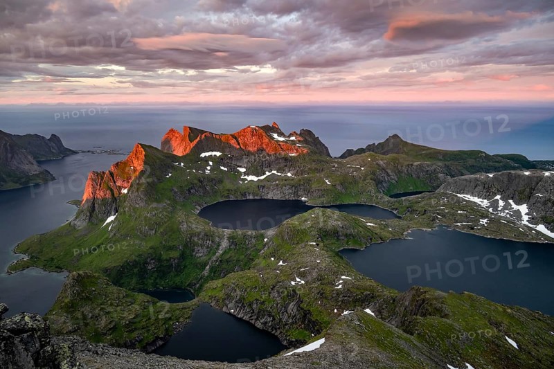 View over mountain peaks and sea, dramatic sunset, from Hermannsdalstinden, with lakes Litlforsvatnet and Tennesvatnet and fjord Forsfjorden, Moskenesöy, Lofoten, Nordland, Norway, Europe