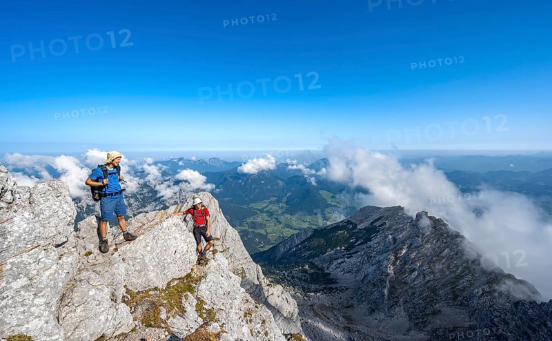 Mountaineer on a rocky narrow mountain path with mountain panorama, mountain tour to the summit of the Hochkalter, Hochkalter crossing, Berchtesgaden Alps, Bavaria, Germany, Europe
