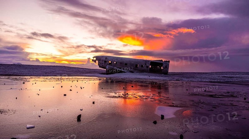 Beautiful aerial drone view at sunrise on crashed plane on frozen Solheimasandur beach in winter, Iceland, Europe