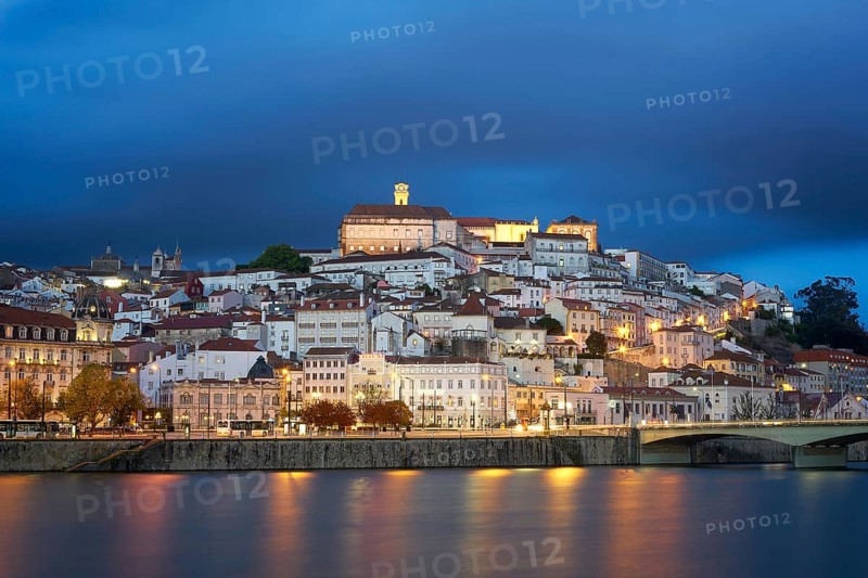 Coimbra city view at night with Mondego river and beautiful historic buildings, in Portugal