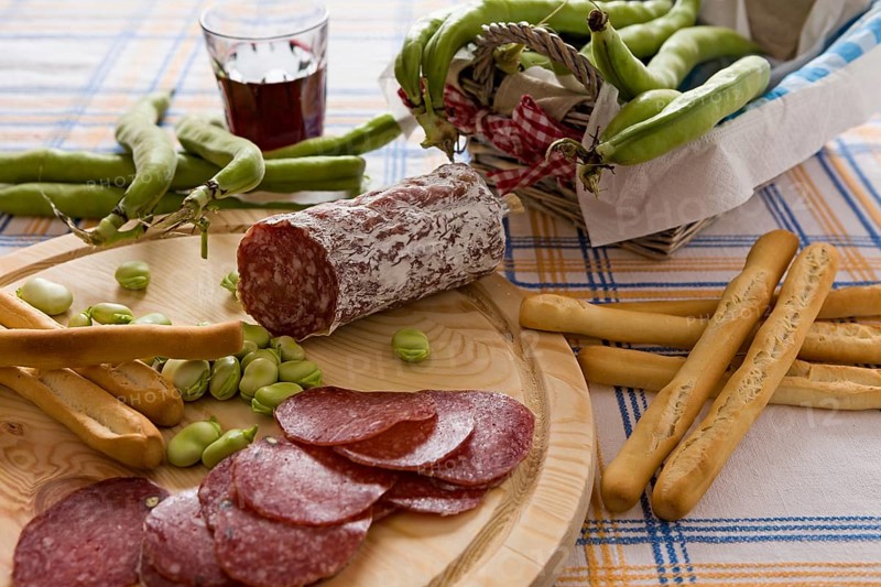 Italian salami broad bean and bread sticks over a chopping board