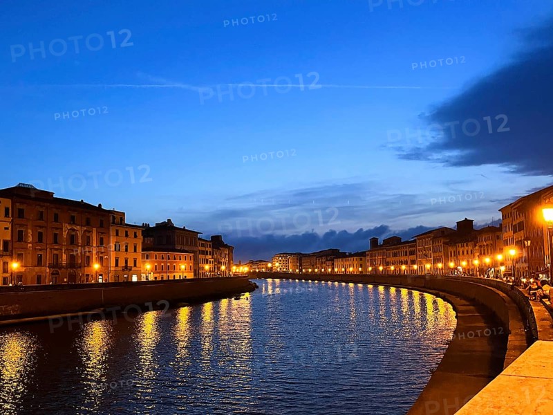 Pisa, Italy. September 16, 2023.The Ponte di Mezzo in the evening and the banks of the Arno River. The Arno River runs through downtown Pisa